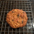 Golden Brown Butter Oatmeal Raisin Cookie with oats and raisins, on a wire cooling rack